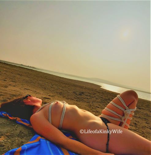 woman laying on beach